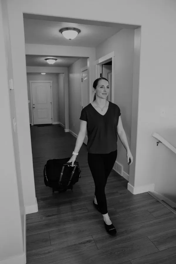 Dr. Danaya arriving at a patient's home with her clinical equipment